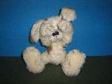 White dog with brown stains.